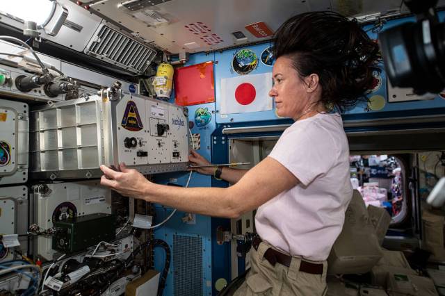 Astronaut Megan McArthur installs a new sample processor