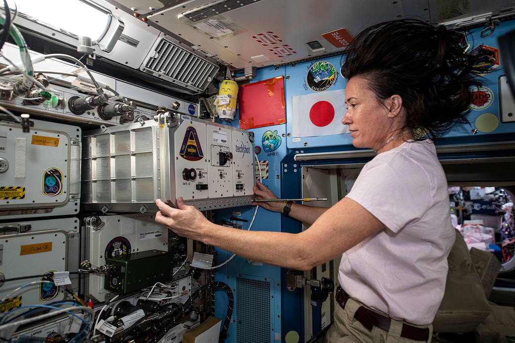 Astronaut Megan McArthur installs a new biology research device