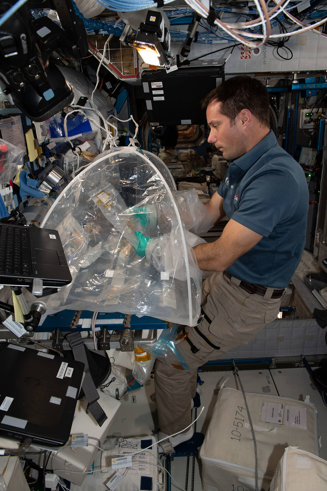 Astronaut Thomas Pesquet works on the Oral Biofilms experiment