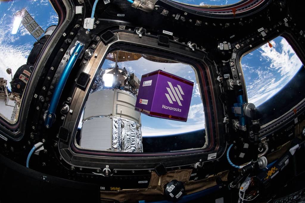A NanoRacks module free-floats inside the cupola