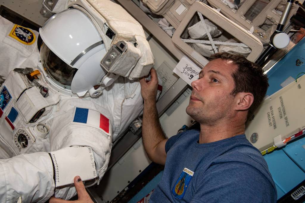 Astronaut Thomas Pesquet checks his U.S. spacesuit
