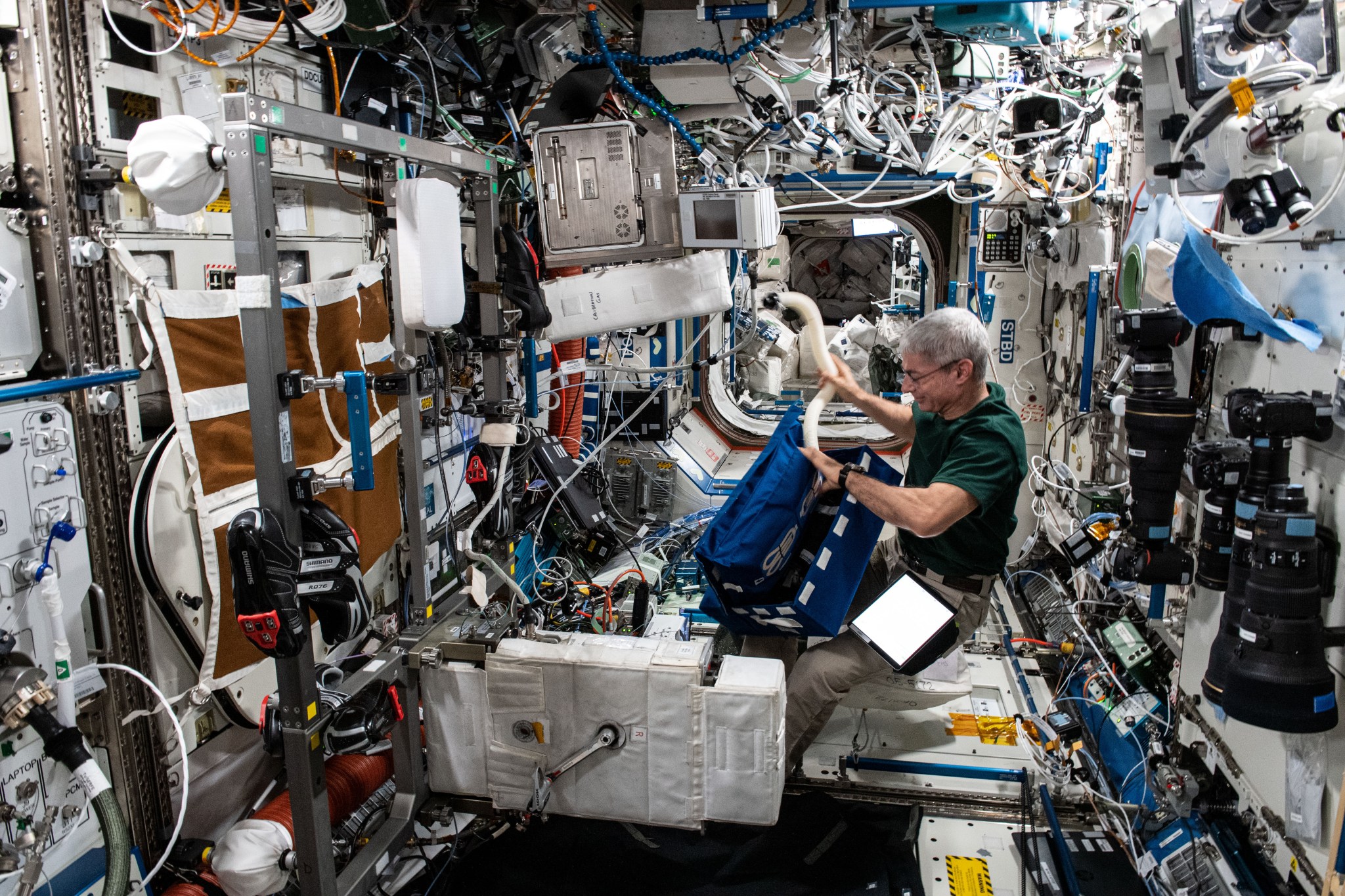 astronaut sets up the International Space Station's exercise bicycle
