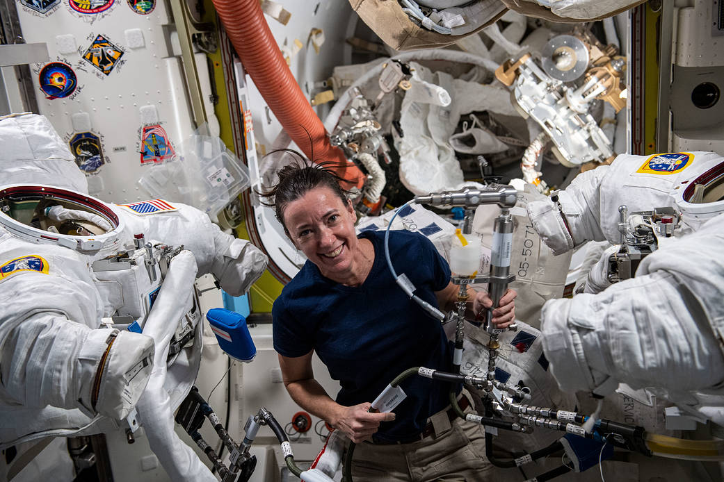 Astronaut Megan McArthur services a pair of U.S. spacesuits