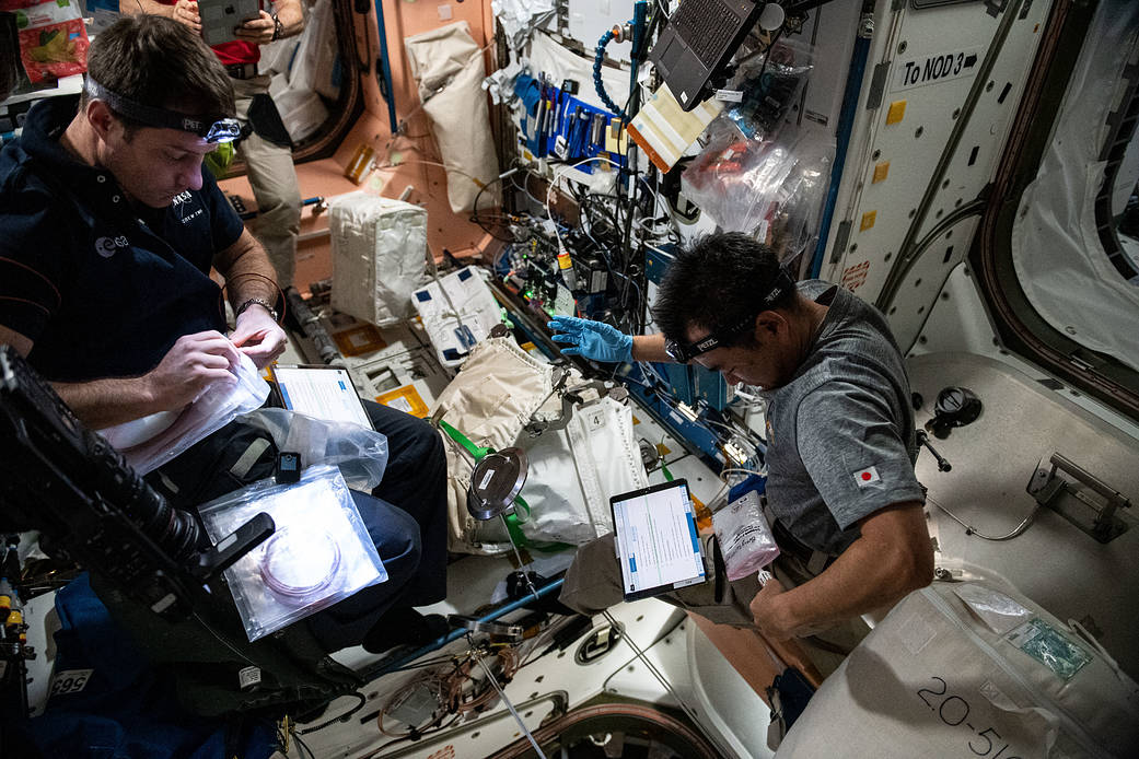 Astronauts Thomas Pesquet and Akihiko Hoshide configure the vestibule