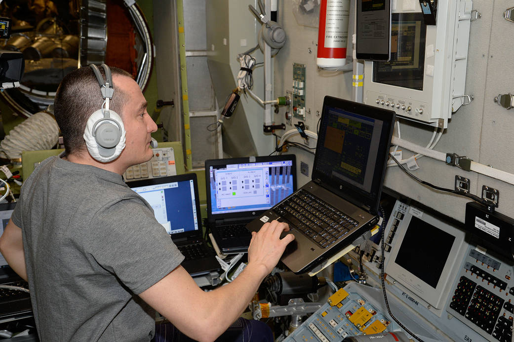 Cosmonaut Pyotr Dubrov practices an emergency drill on a computer