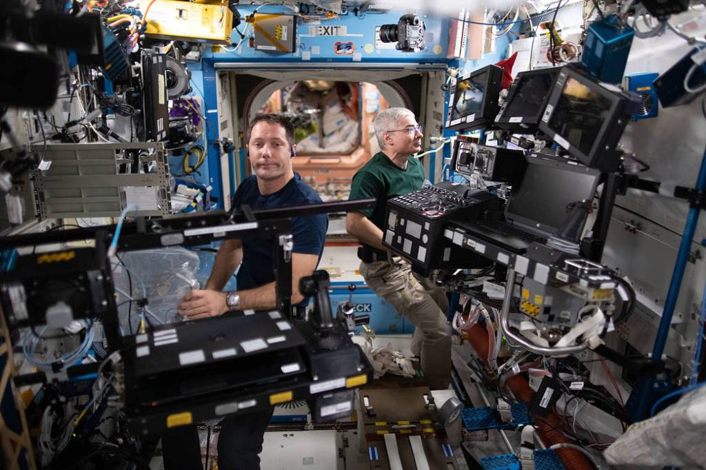 Astronauts Thomas Pesquet and Mark Vande Hei service a variety of hardware
