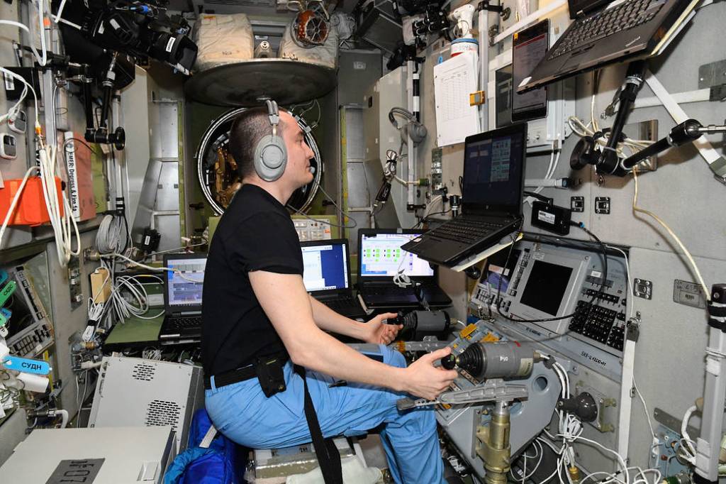 Cosmonaut Pyotr Dubrov practices remote spacecraft maneuvering techniques