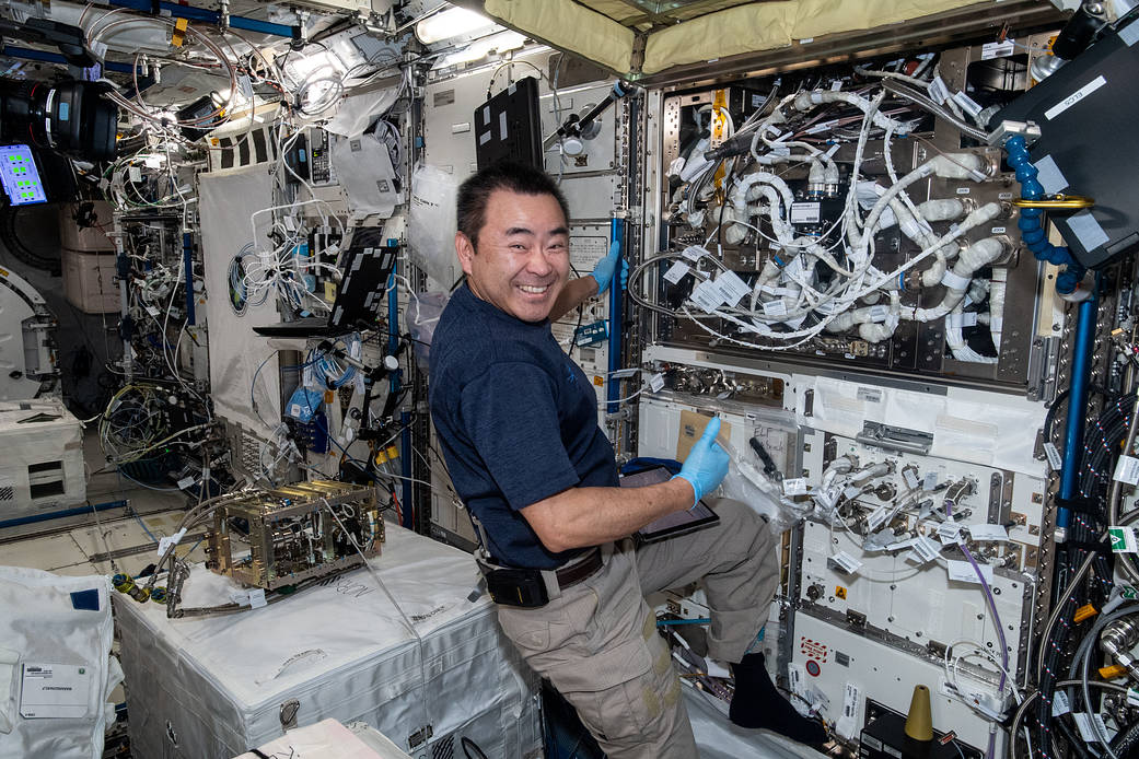 Commander Akihiko Hoshide works on science maintenance