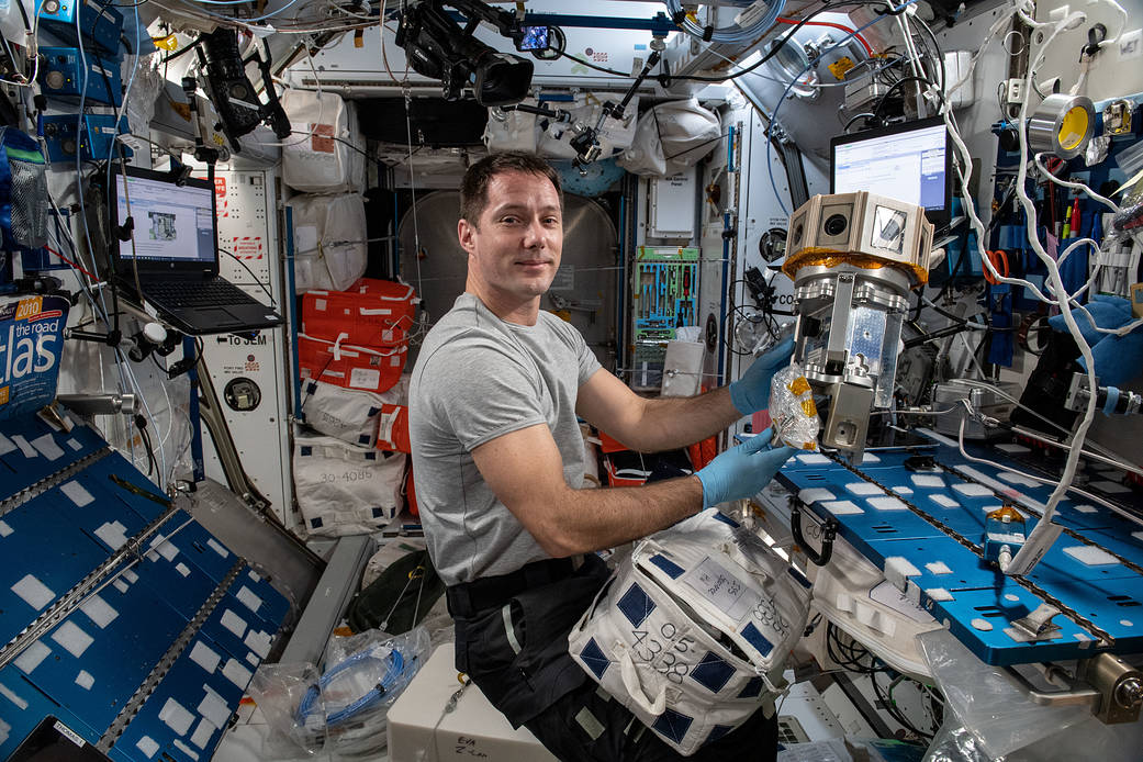 Astronaut Thomas Pesquet sets up a virtual reality camera