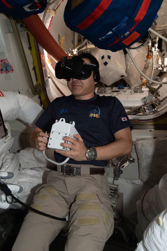 Commander Akihiko Hoshide wears virtual reality goggles