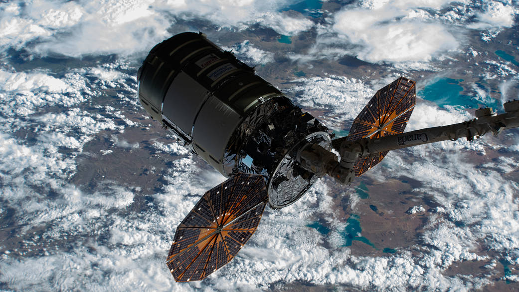 The Cygnus space freighter in the grips of the Canadarm2 robotic arm