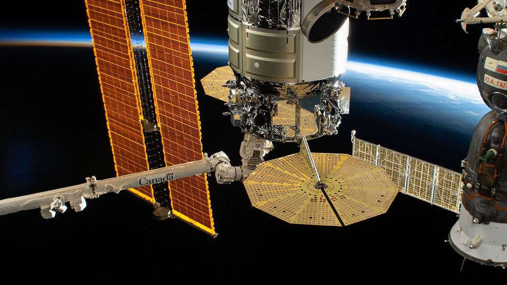 The Cygnus space freighter in the grips of the Canadarm2 robotic arm