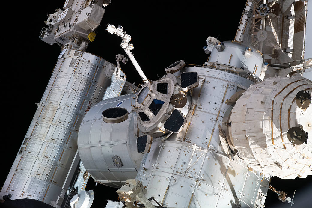 Key portions of the International Space Station are pictured from a window on the Nauka Multipurpose Laboratory Module. From left to right are, the Kibo laboratory module, the Japanese robotic arm, the Permanent Multipurpose Module, the Tranquility module, the cupola, and the Bigelow Expandable Activity Module (BEAM).