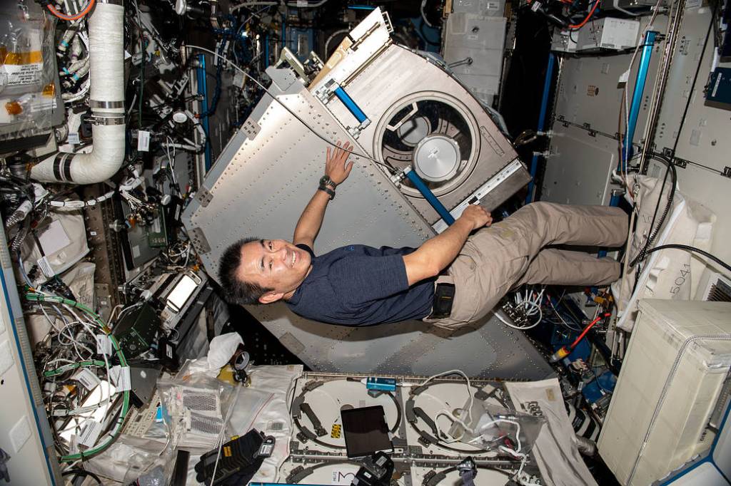 Commander Akihiko Hoshide rotates the Microgravity Science Glovebox