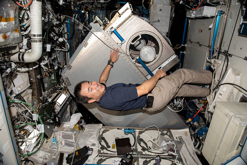 Commander Akihiko Hoshide rotates the Microgravity Science Glovebox