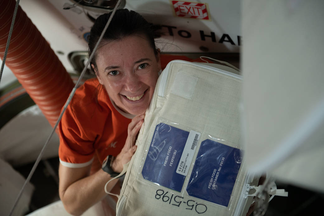 Astronaut Megan McArthur unpacks a fresh food container