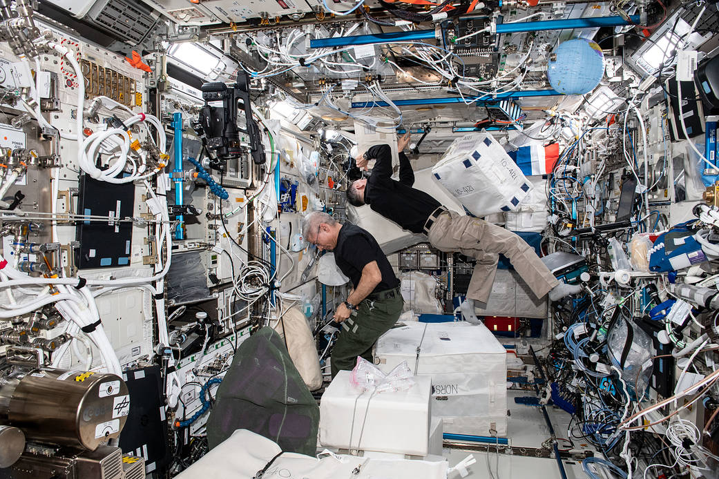 Astronauts Mark Vande Hei and Shane Kimbrough unpack cargo bags