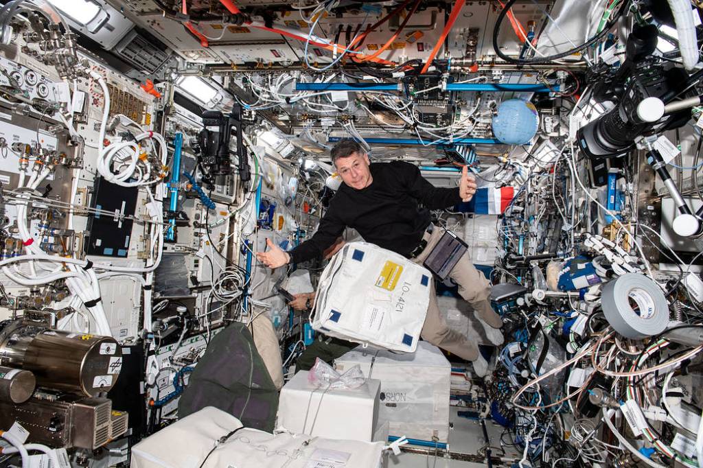 NASA astronaut Shane Kimbrough unpacks cargo bags