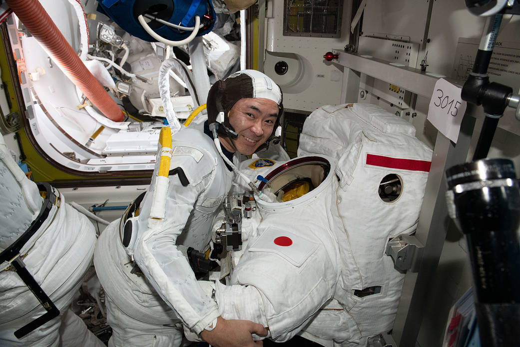 Astronaut Akihiko Hoshide conducts a spacesuit fit check
