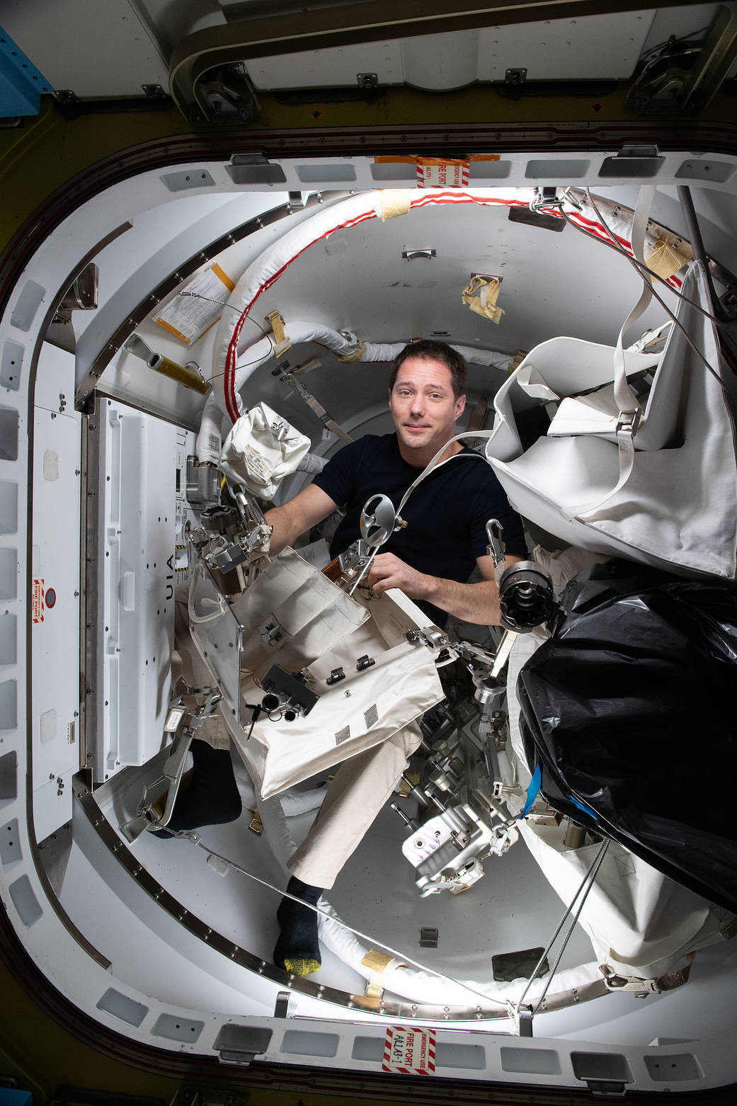 Astronaut Thomas Pesquet checks a variety of spacewalk tools