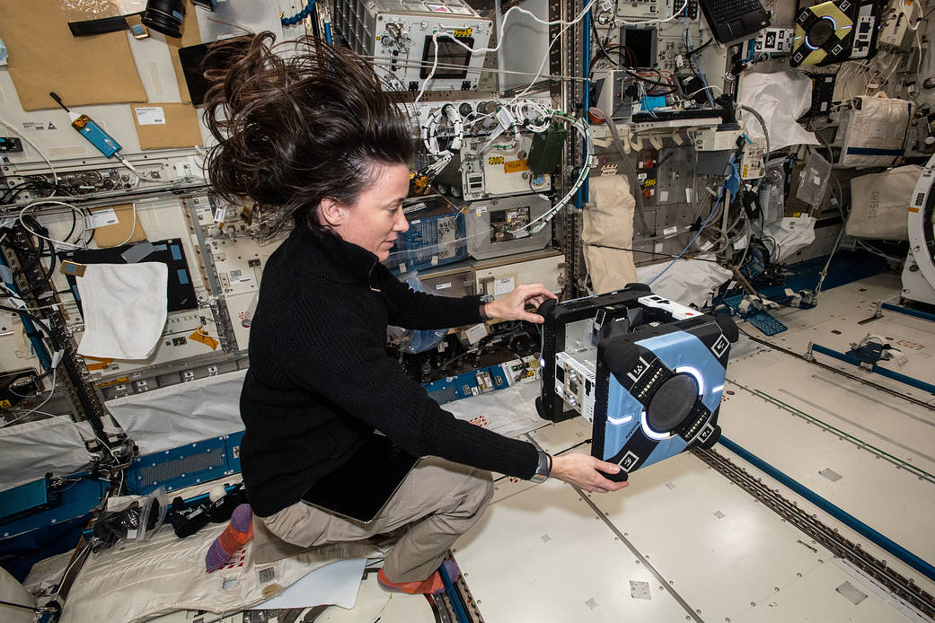 Astronaut Megan McArthur sets up an Astrobee robotic free-flyer