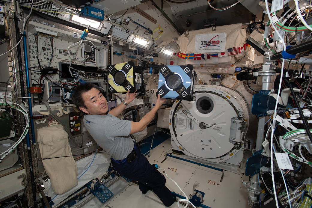 Astronaut Akihiko Hoshide checks out Astrobee robotic free-flyers