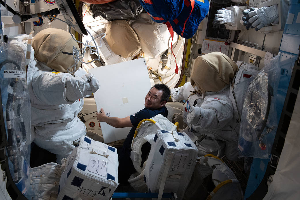 Astronaut Akihiko Hoshide works on U.S. spacesuit components