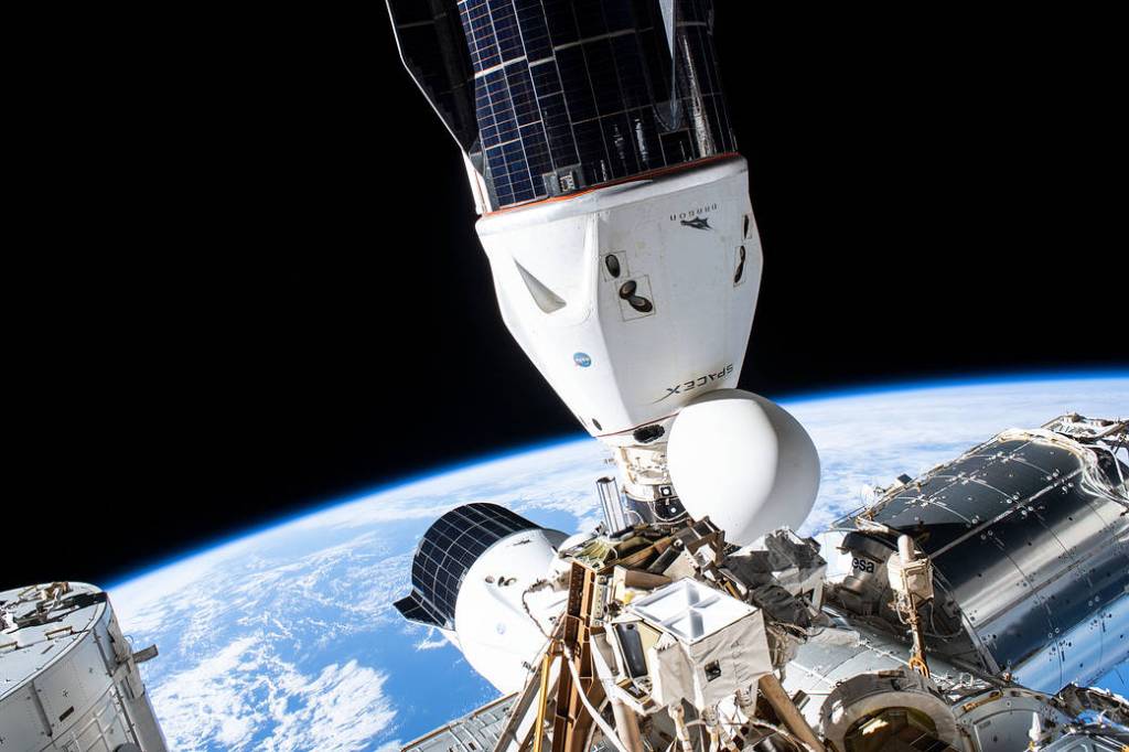 The SpaceX Cargo Dragon and Crew Dragon vehicles docked to the station
