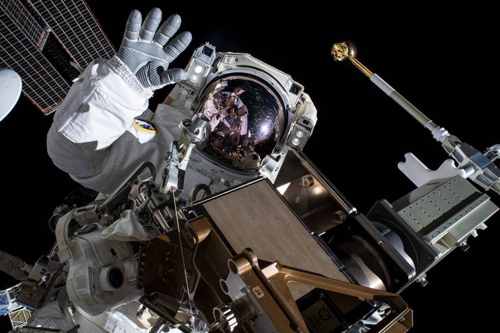 Astronaut Thomas Pesquet waves during a spacewalk