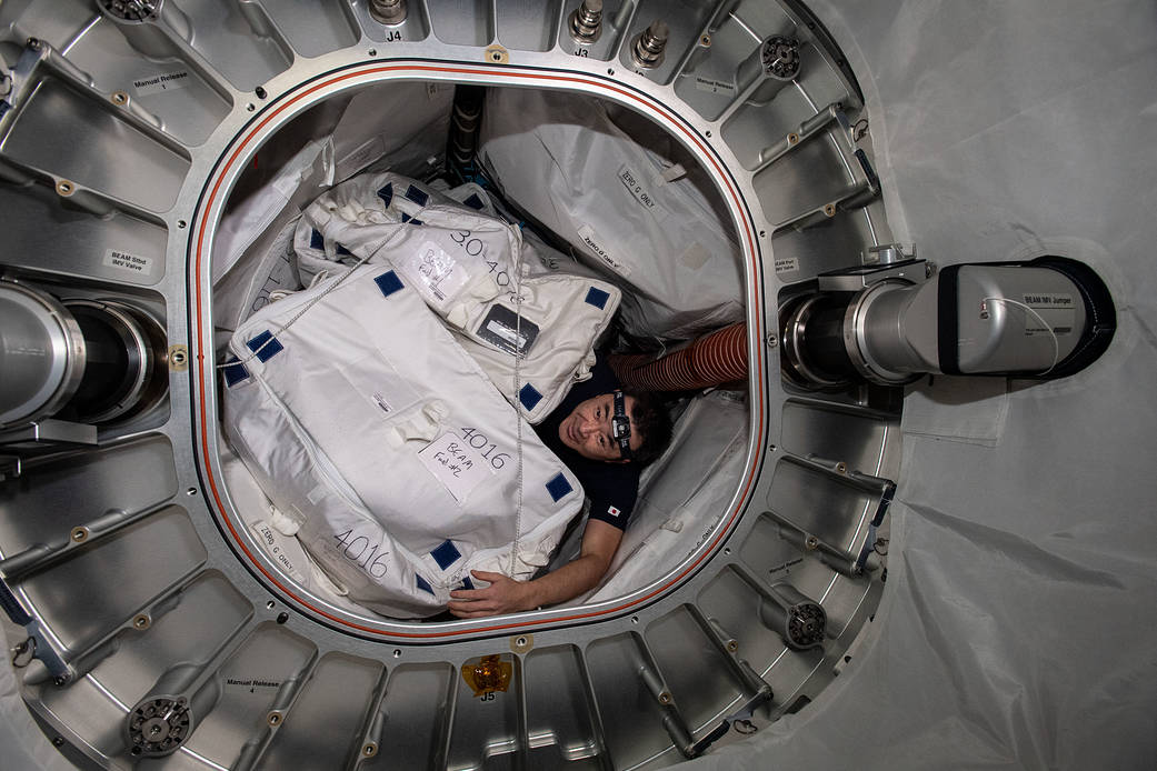 Astronaut Akihiko Hoshide gathers hardware from inside BEAM