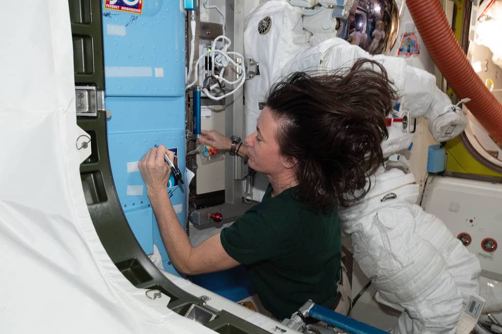 Astronaut Megan McArthur signs the station vestibule