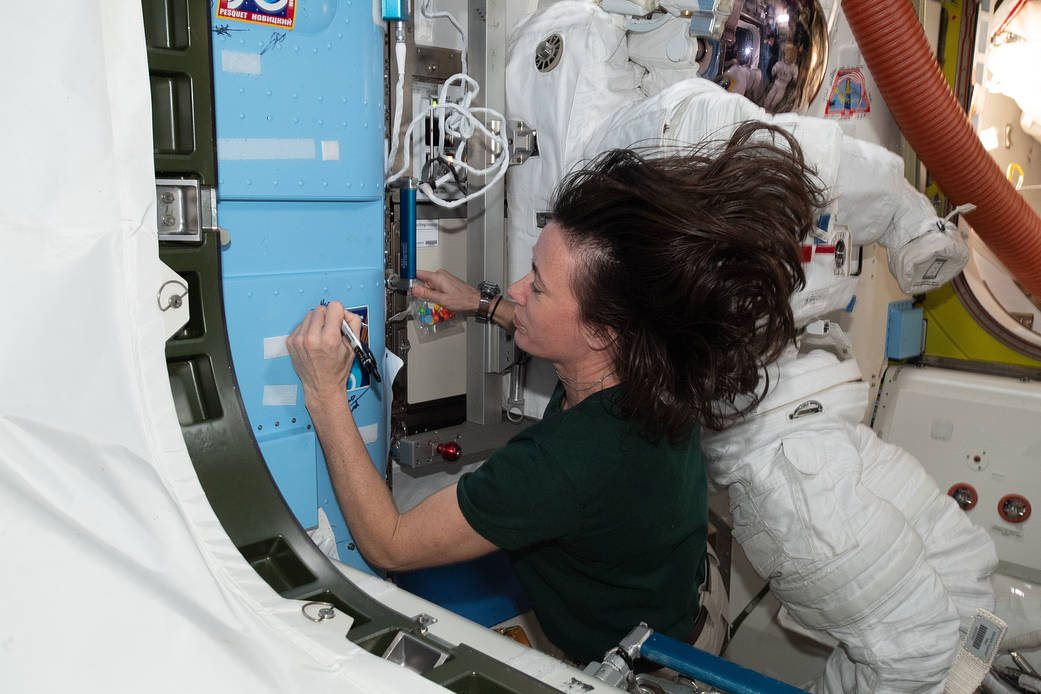 Astronaut Megan McArthur signs the station vestibule