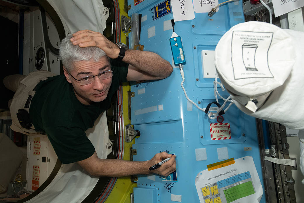 Astronaut Mark Vande Hei signs the station vestibule