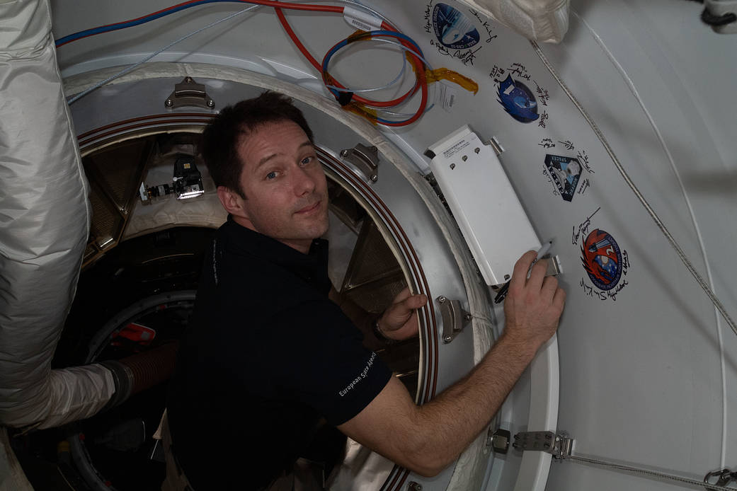 Astronaut Thomas Pesquet signs the station vestibule