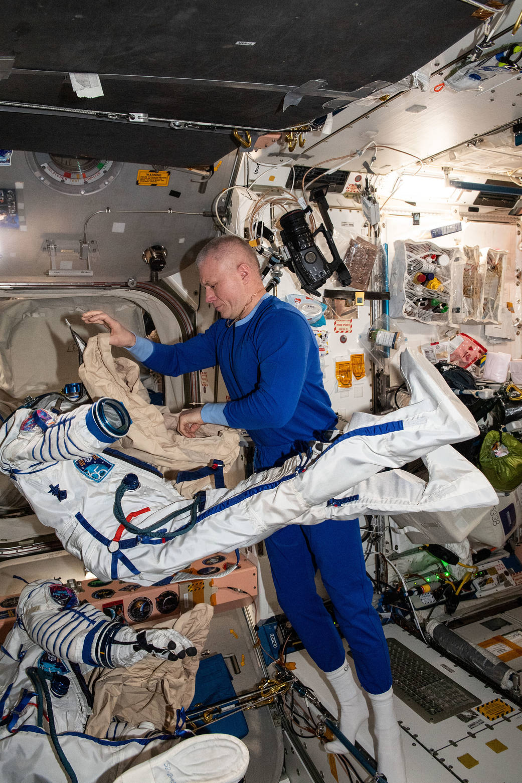 Cosmonaut Oleg Novitskiy tries on the Sokol launch and entry suit
