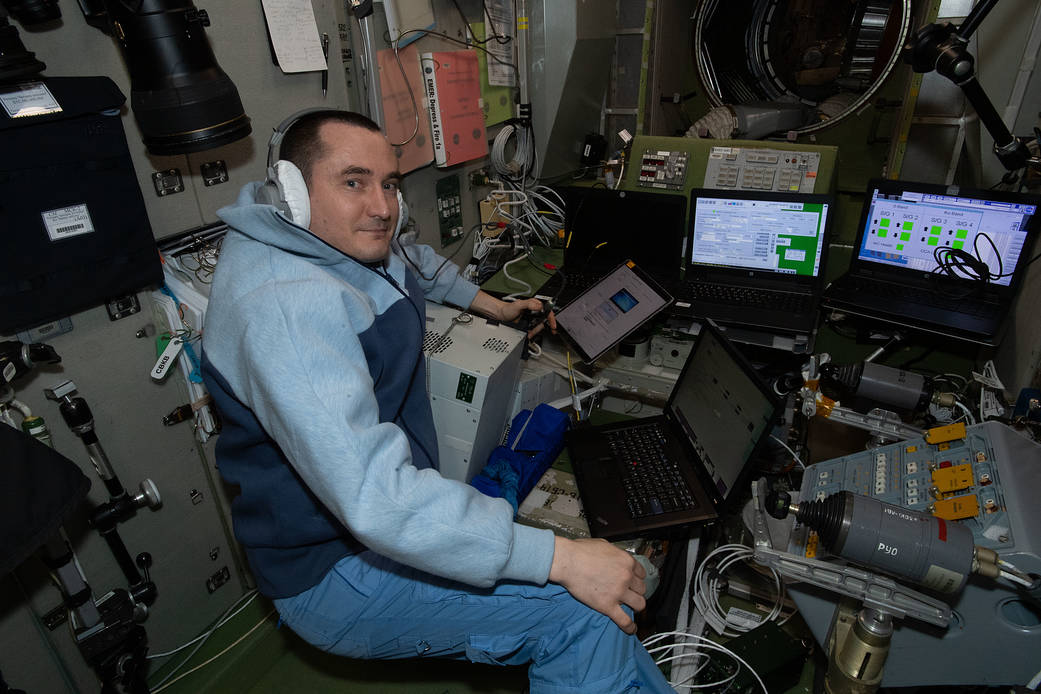 Cosmonaut Pyotr Dubrov performs computer tasks.