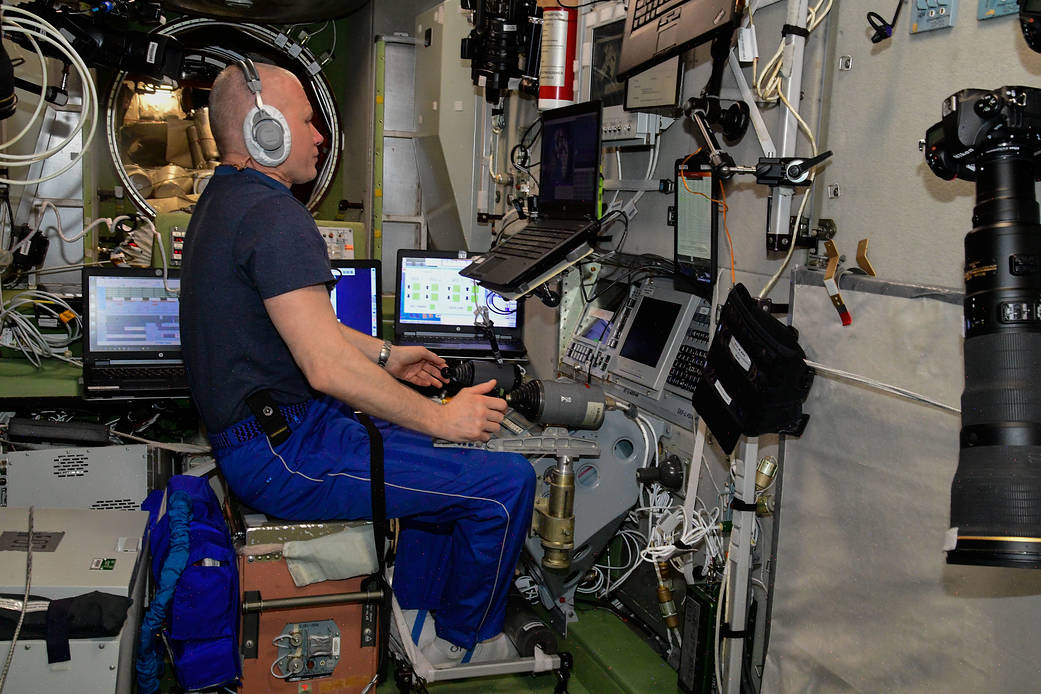 Cosmonaut Oleg Novitskiy trains on a computer.
