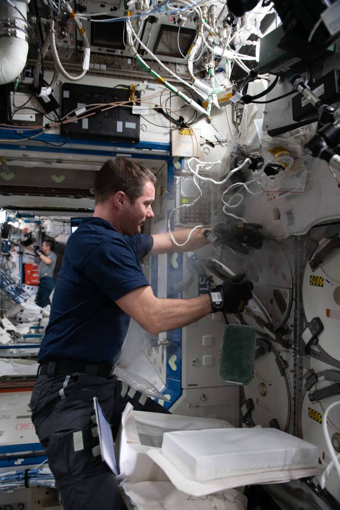 Astronaut Thomas Pesquet collects frozen research samples