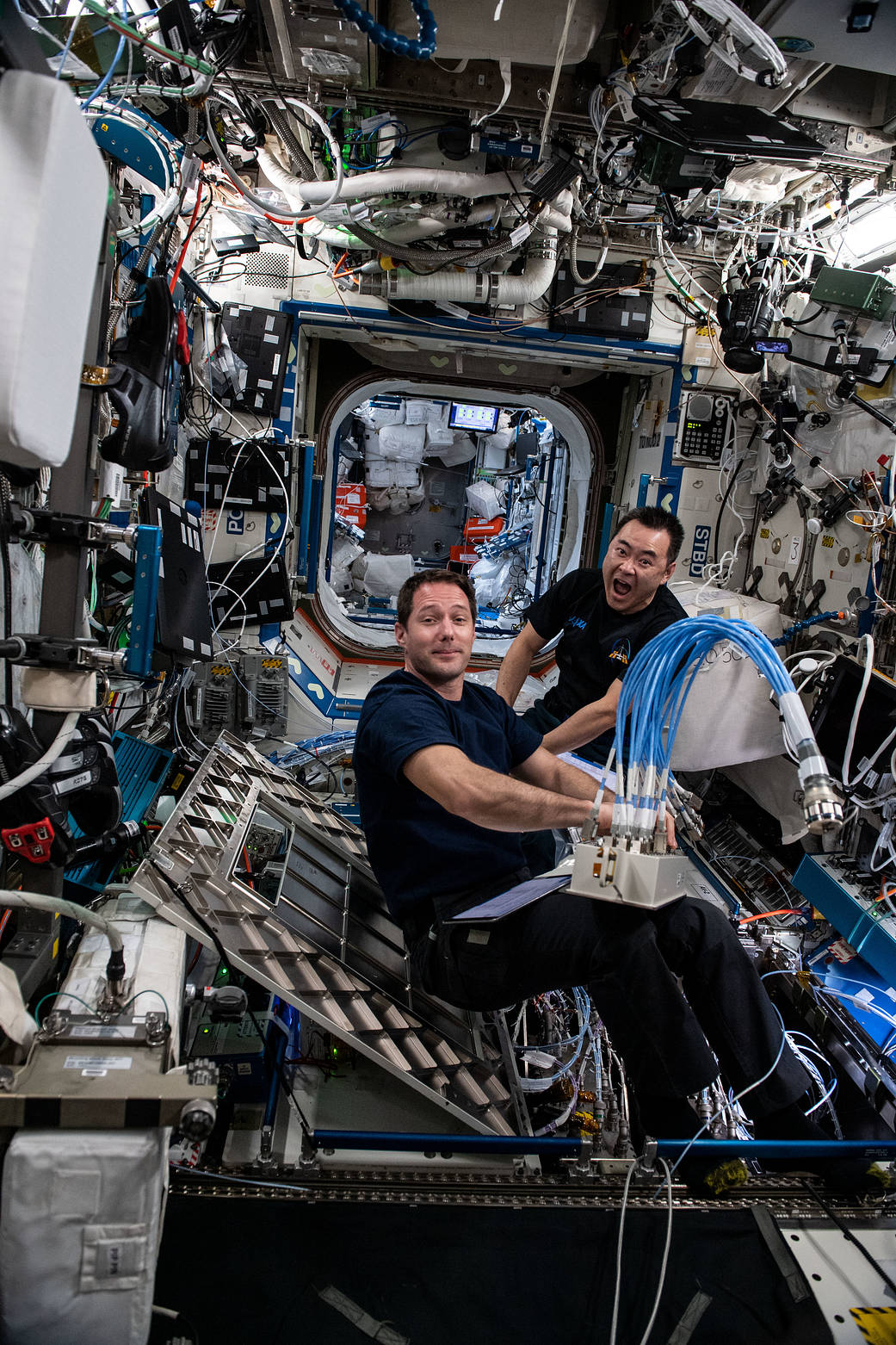 Astronauts Thomas Pesquet and Akihiko Hoshide install a router