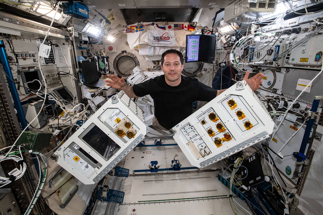 Astronaut Thomas Pesquet gathers research hardware