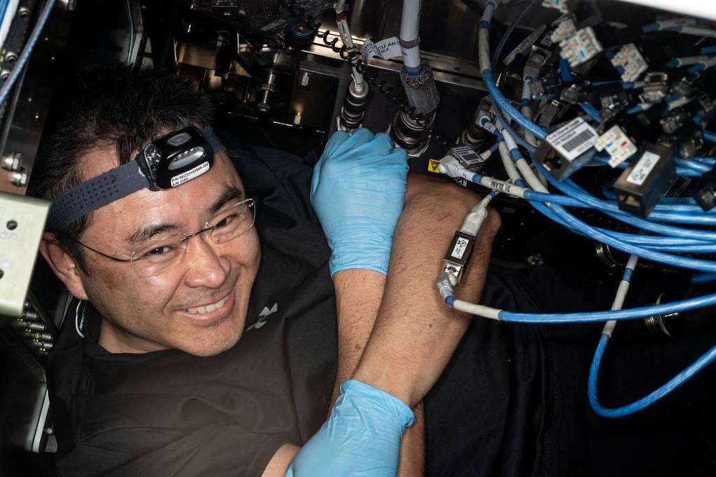 Astronaut Akihiko Hoshide inspects network connections