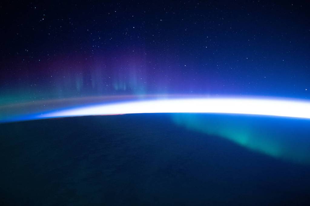 A faint aurora beneath a starry sky