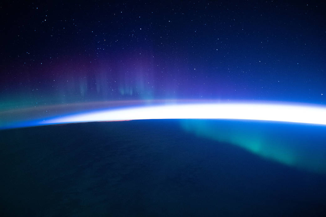 A faint aurora beneath a starry sky