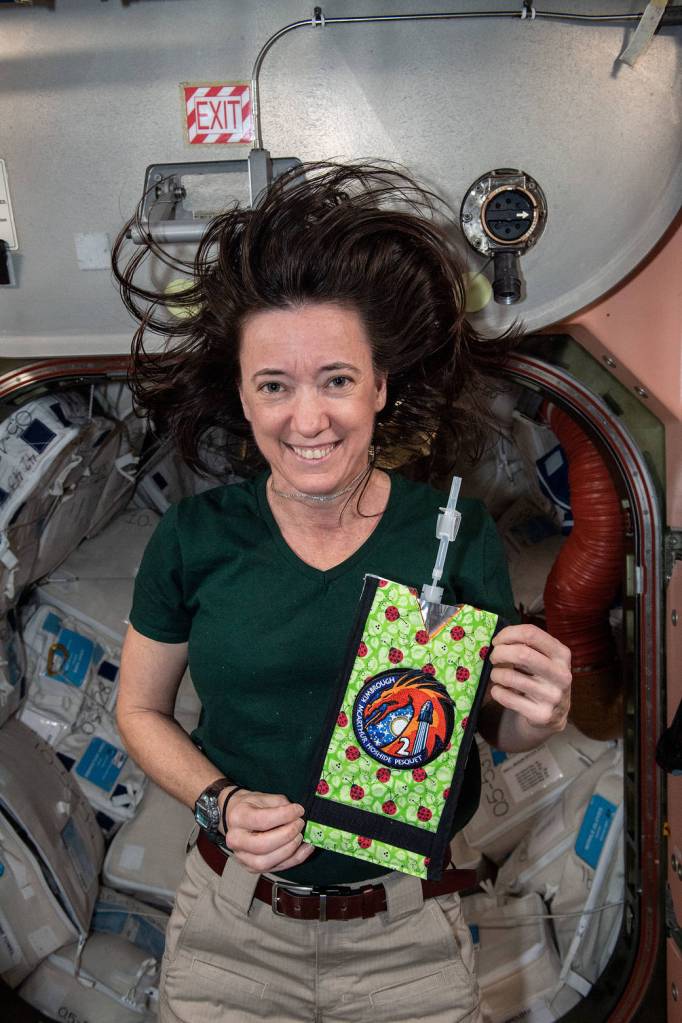 NASA astronaut Megan McArthur holds a personalized drink pouch
