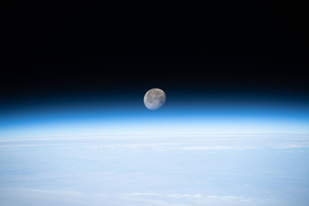The waning gibbous Moon above Earth's horizon