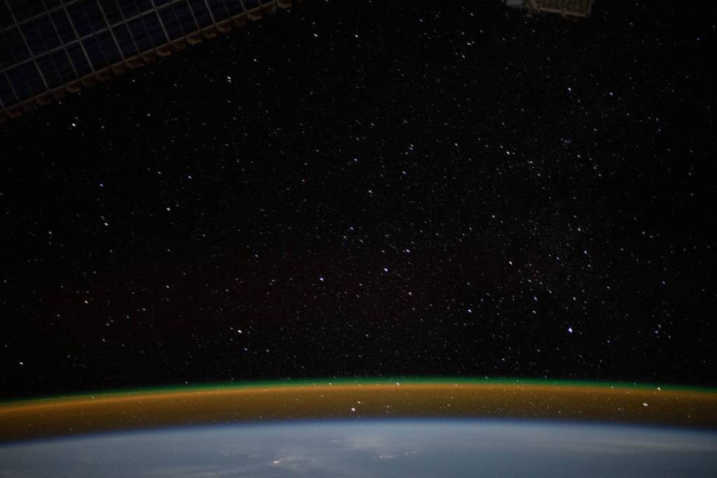 The airglow blankets the Earth’s horizon beneath a starry sky