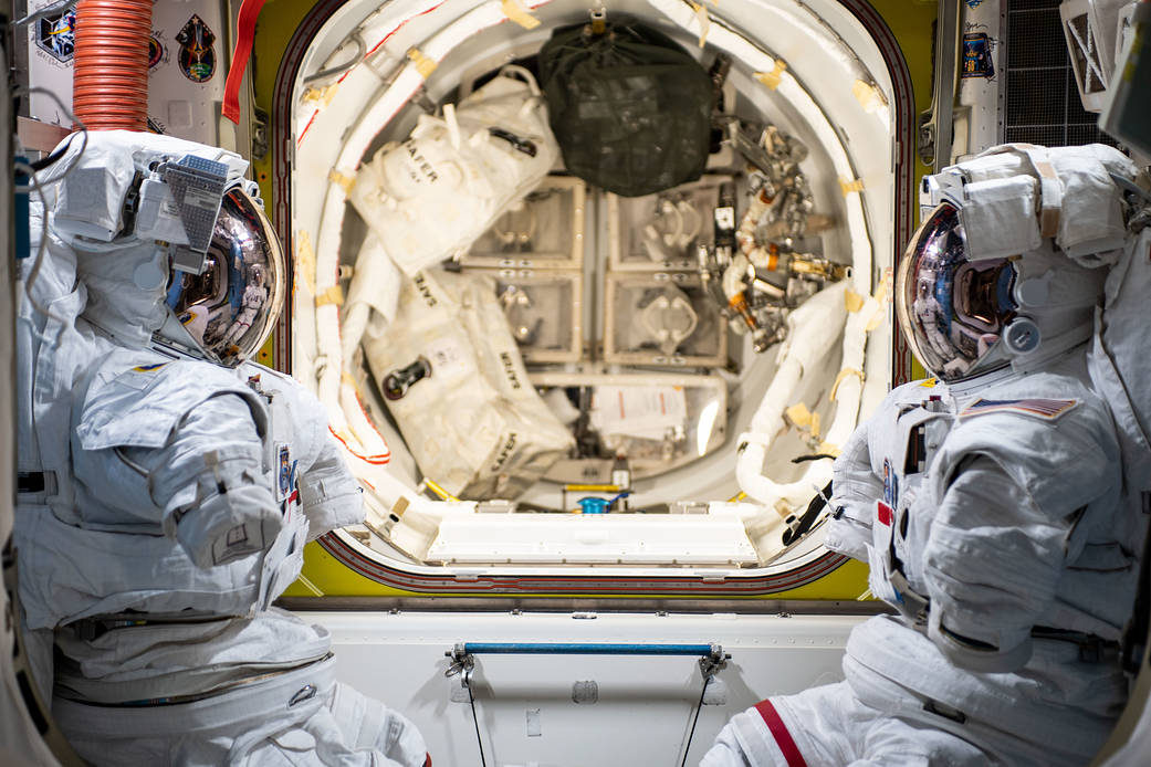 A pair of U.S. spacesuits are pictured inside the U.S. Quest airlock