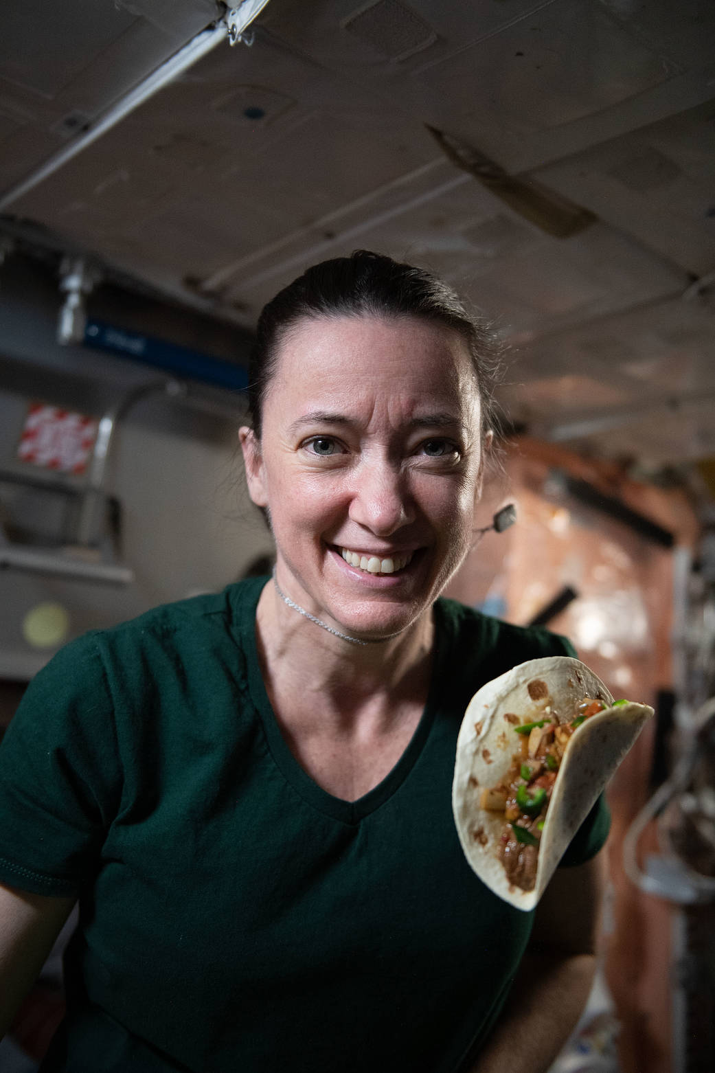 Astronaut Megan McArthur shows off a taco with space-grown chile peppers