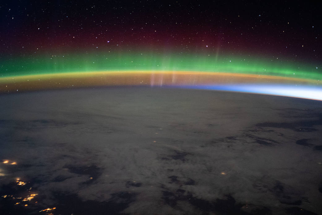 A bright aurora crowns Earth's horizon