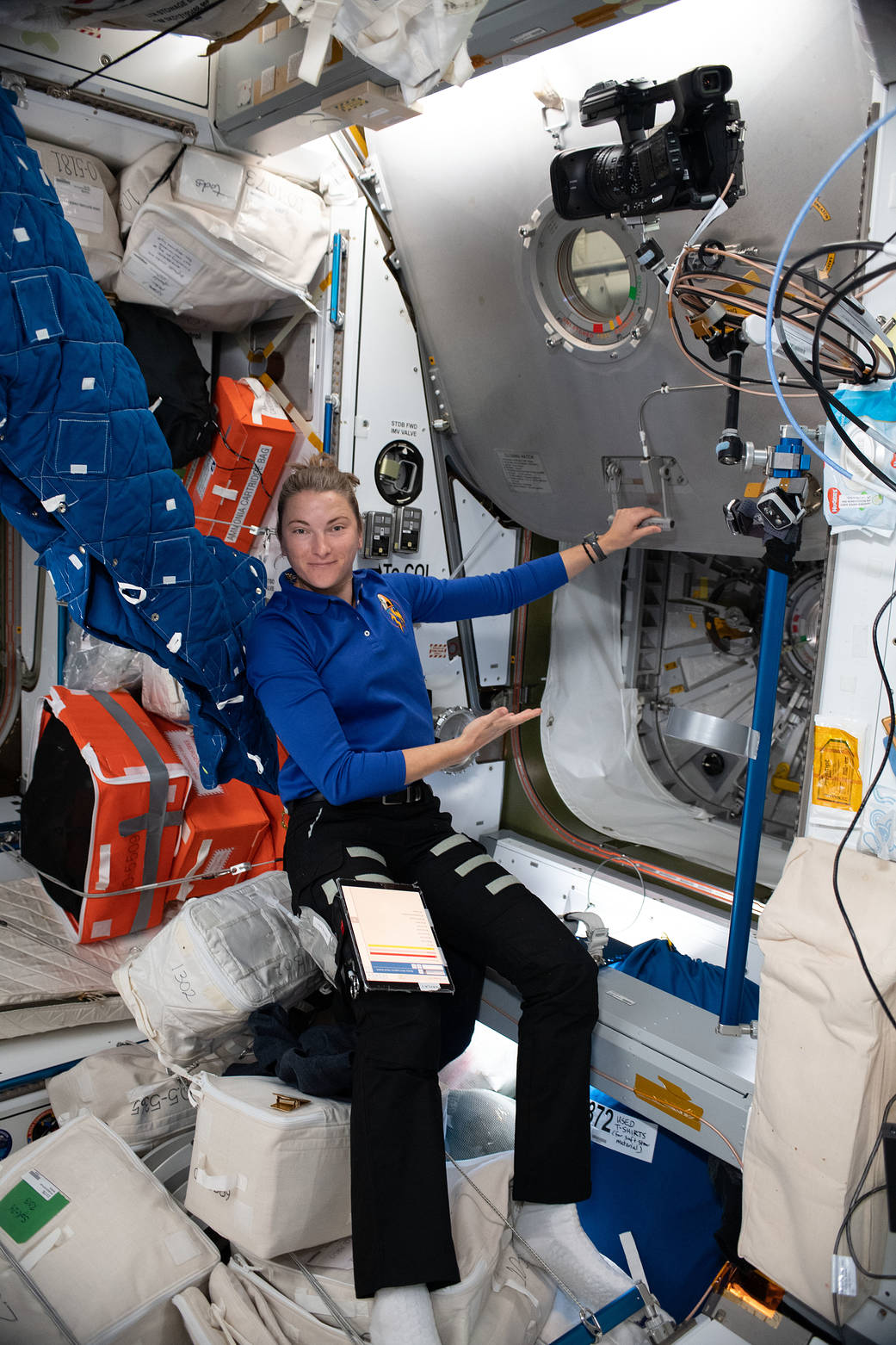 Astronaut Kayla Barron opens the hatch to the Columbus laboratory module